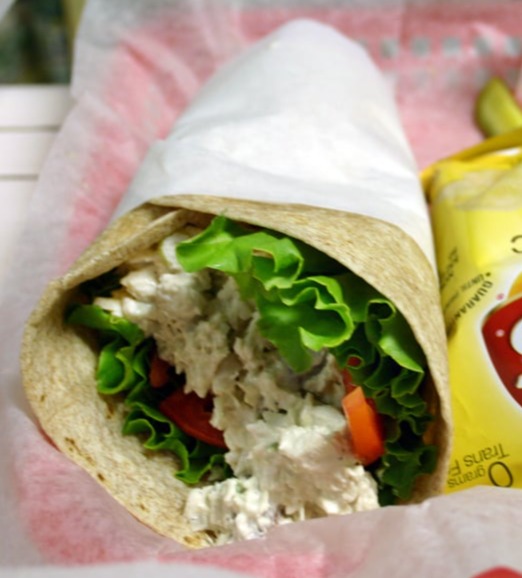 chicken salad wraps sandwich and a bag of lays chips