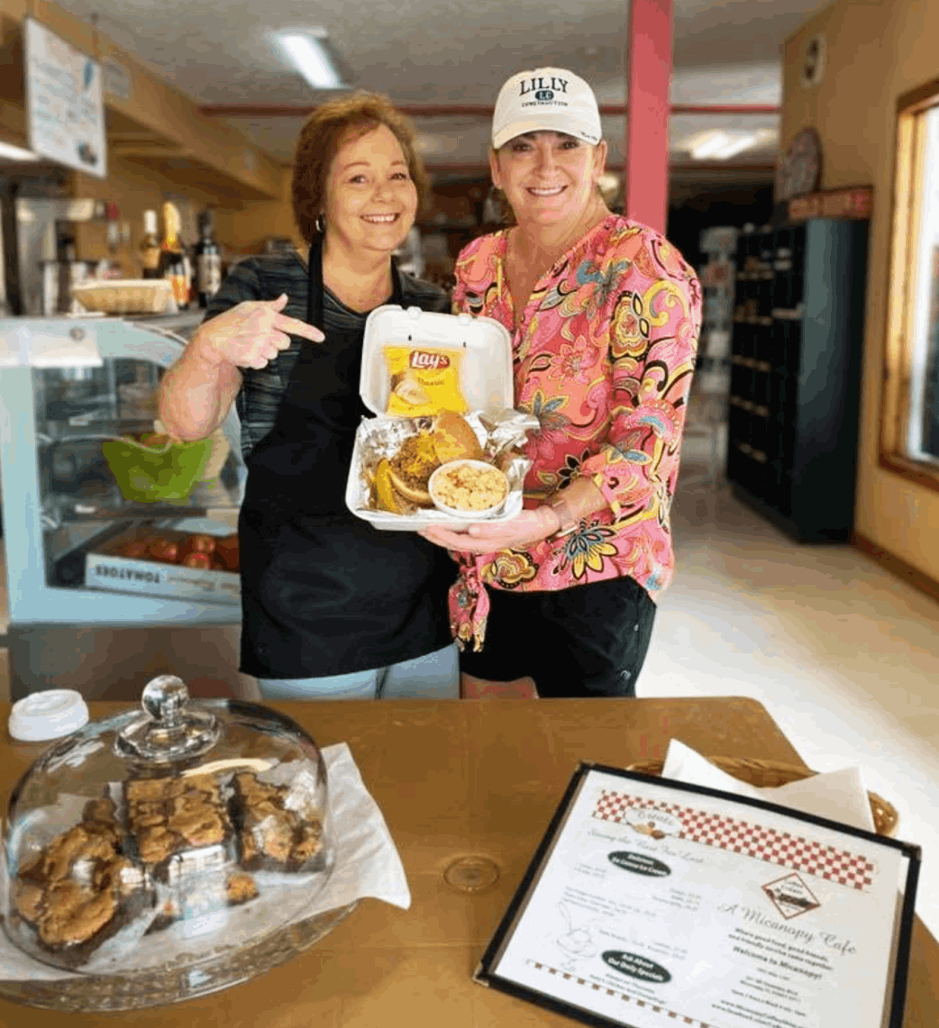 Owner of coffee n cream kelly harris with staff hold foodKelly